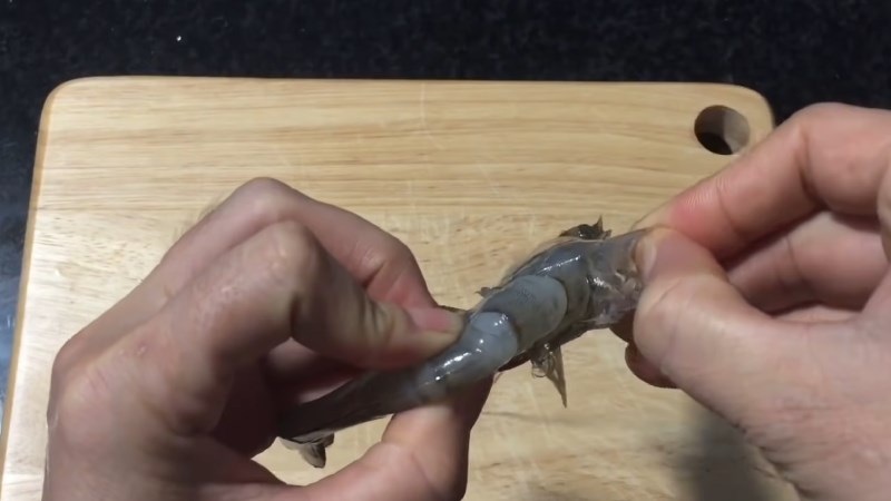 Bóc bỏ phần đầu tôm rồi lột vỏ