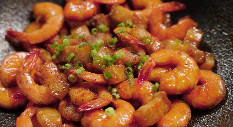 Thịt kho tôm sánh màu, rắc thêm tiêu và hành lá lên trên
