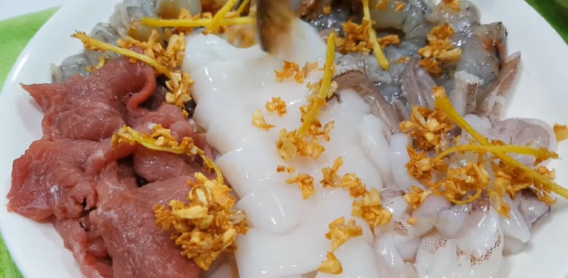 Tôm, mực và thịt ướp với tỏi gừng phi