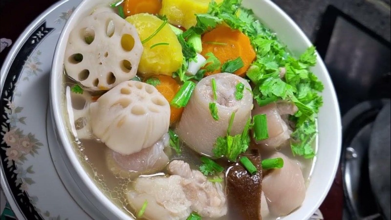 Tô canh củ sen hầm đuôi heo cùng cà rốt và khoai, rắc hành ngò tươi