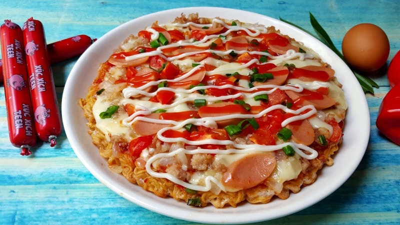 Pizza bằng mì tôm trang trí thêm xúc xích, hành lá,...