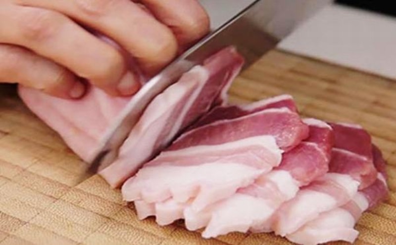 Thái thịt ba rọi heo thành lát mỏng để chuẩn bị ướp nướng