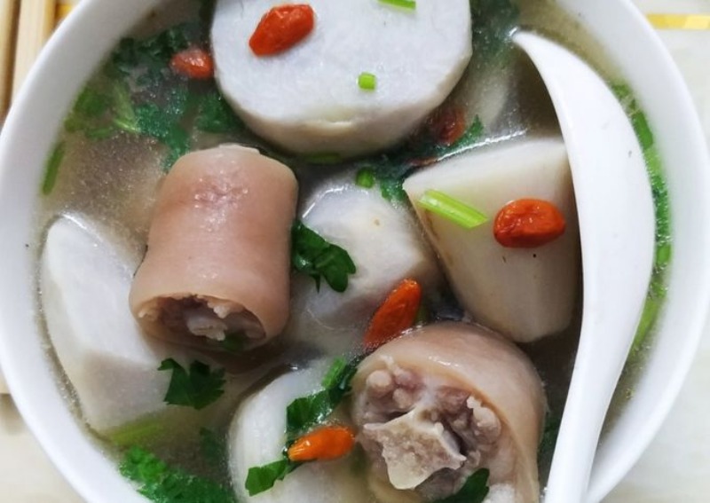 Canh đuôi heo hầm khoai môn với kỷ tử, rau thơm, và khoai chín mềm