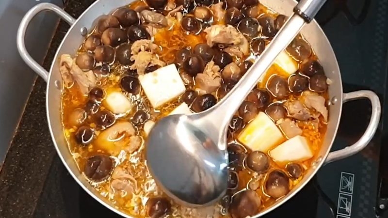 Nồi thịt gà nấu cùng nấm rơm và củ cải trắng đang sôi