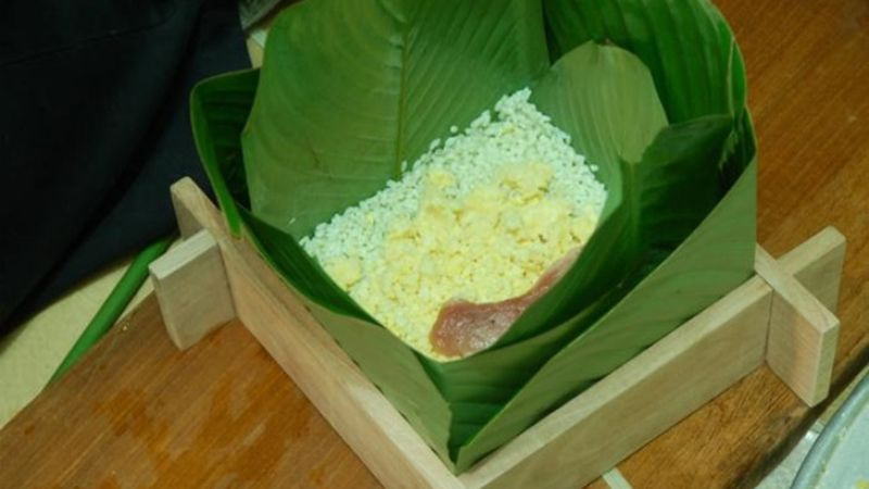 Xếp lá dong vào khuôn và cho nguyên liệu vào